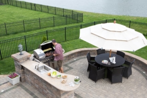 aerial-view-of-homeowner-grilling-in-outdoor-kitchen Aerial view of homeowner grilling in outdoor kitchen
